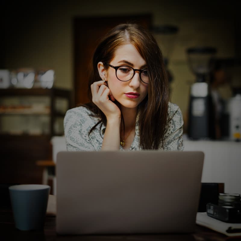 A woman reading content written by TheOneStopWeb.Shop