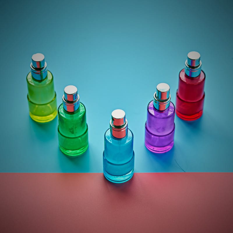 Different coloured bottles of perfume demonstrating product variations in WooCommerce