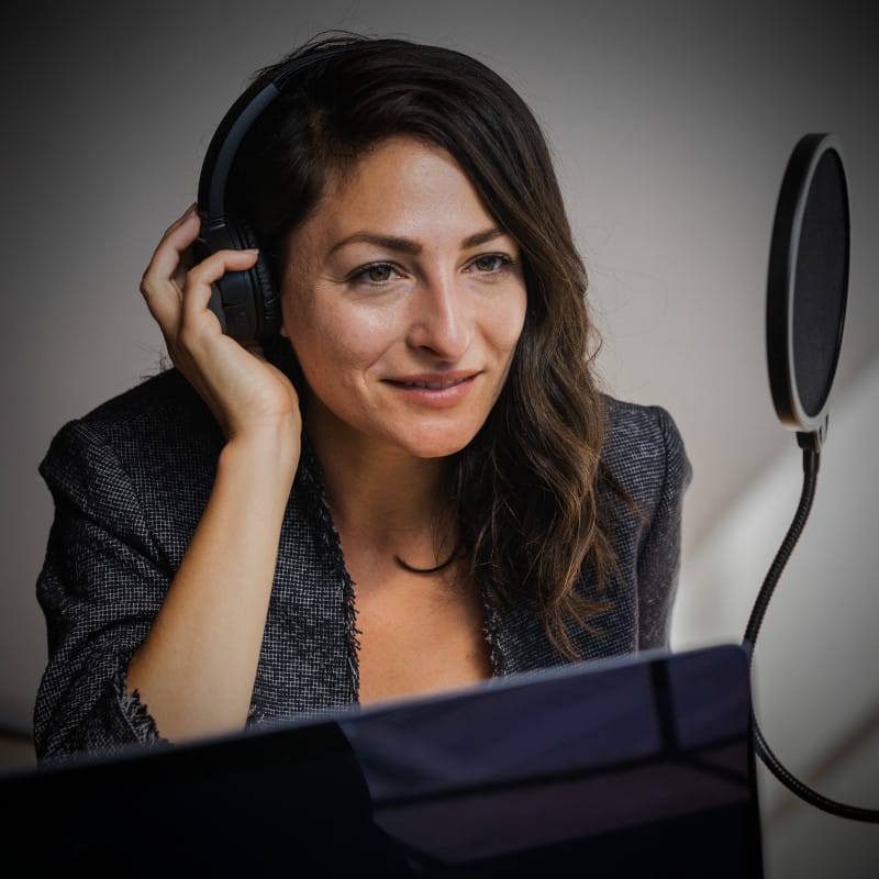 A woman records a padcast with TheOneStopWeb.Shop