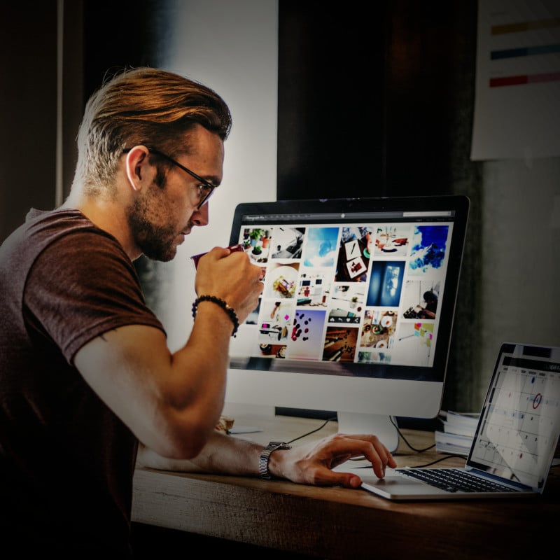A man sourcing photographs for a website