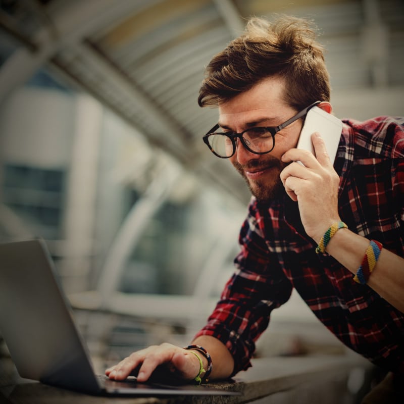 A man picks up the phone and talks to TheOneStopWeb.Shop