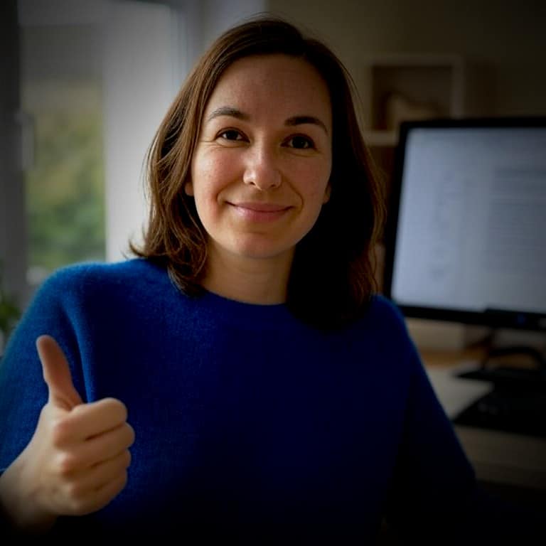A happy woman gives a thumbs up